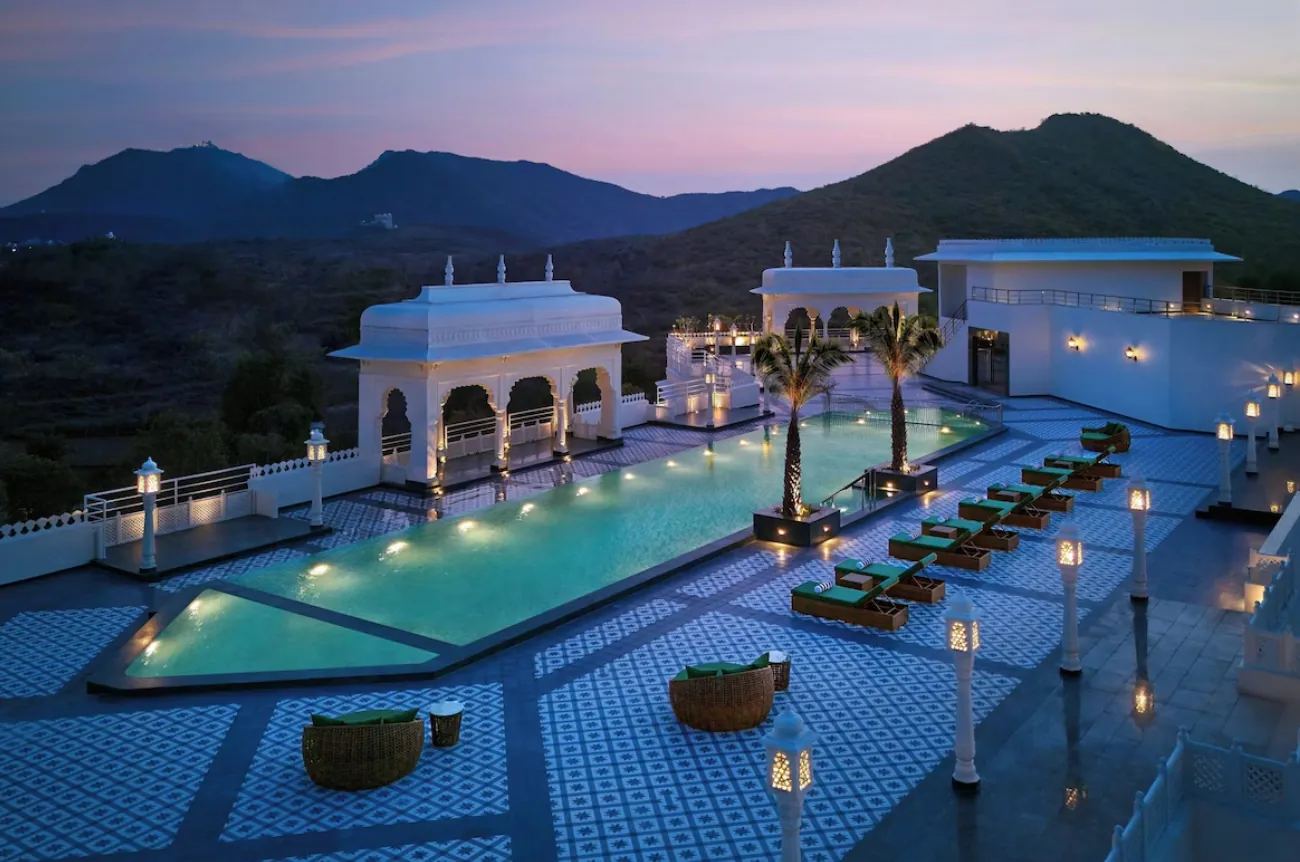 A rooftop pool at dusk at an aspirational Indian hotel — the kind of high-cash-rate stay where a Marriott Bonvoy points transfer delivers the most value.